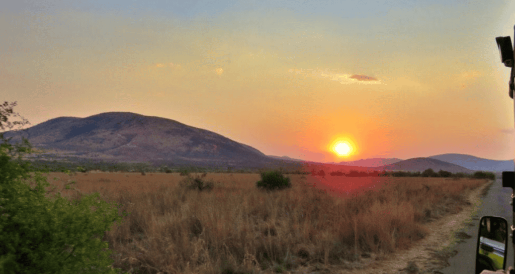 Sunset over the plains at Pilanesberg National Park during a safari.